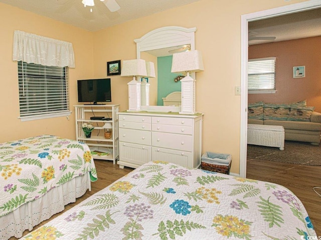 bedroom with ceiling fan and dark wood-type flooring