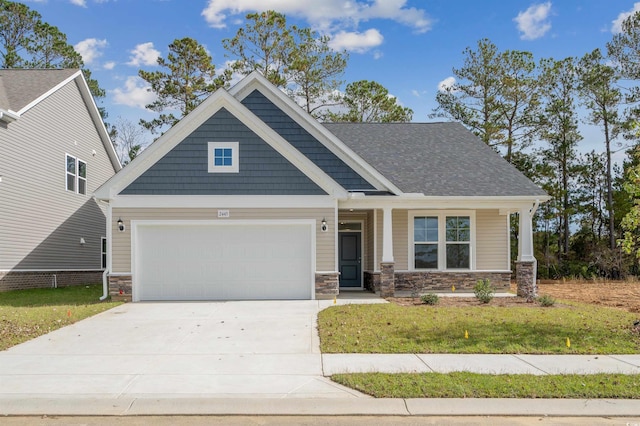 craftsman house featuring a front yard, a garage, and covered porch