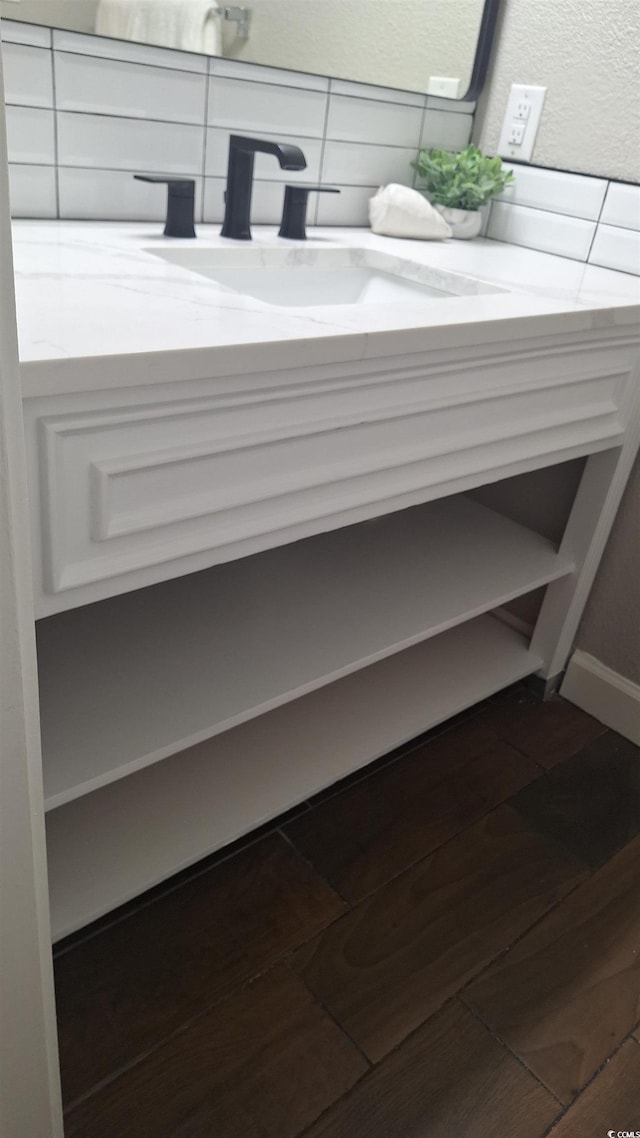 interior details with vanity and hardwood / wood-style flooring