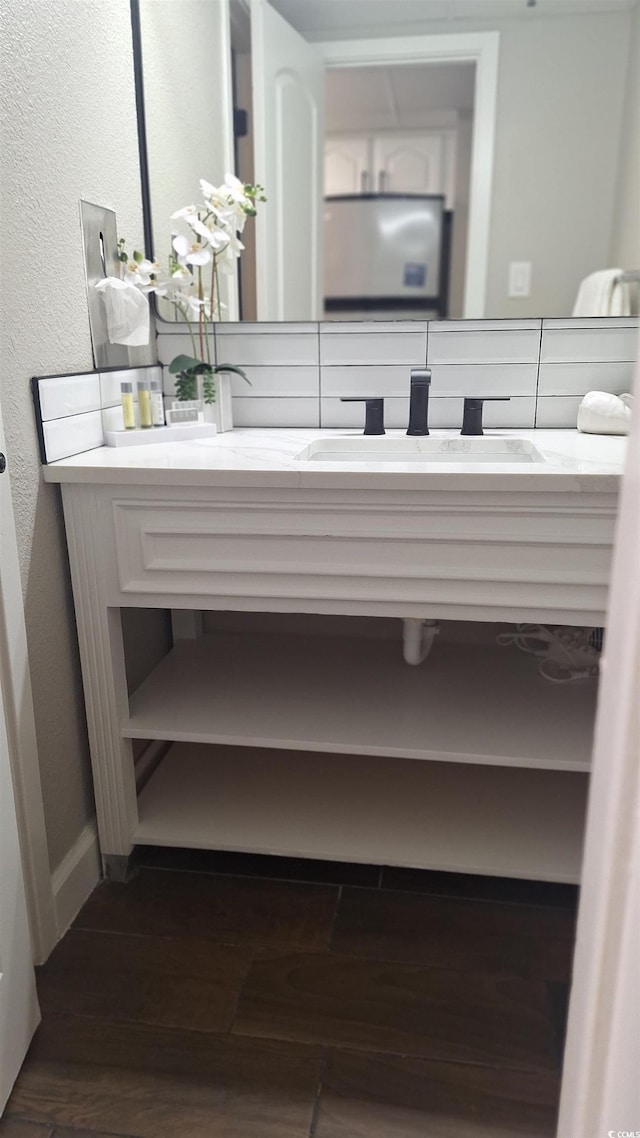 bathroom featuring hardwood / wood-style flooring and vanity