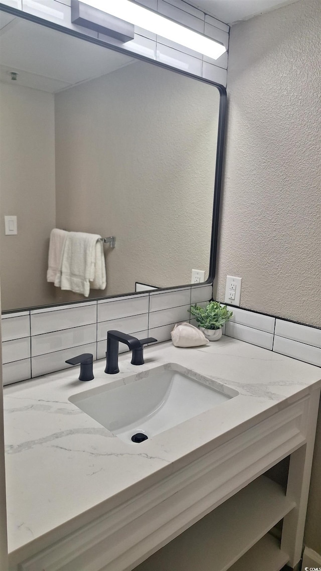 bathroom featuring backsplash and vanity