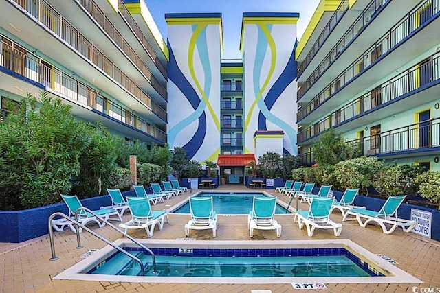 view of swimming pool with a community hot tub