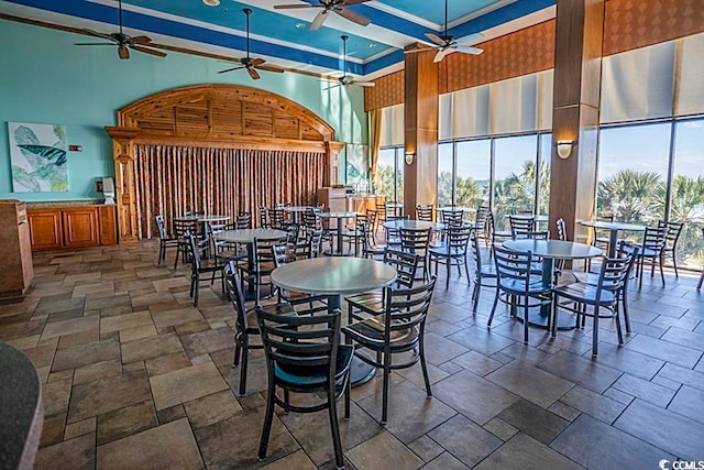 dining area featuring a towering ceiling