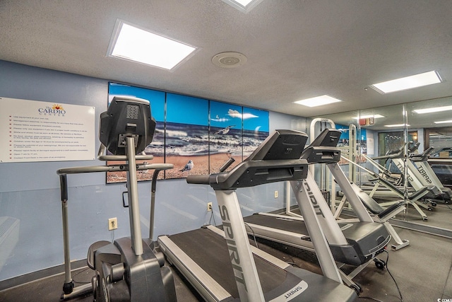 exercise room with a textured ceiling