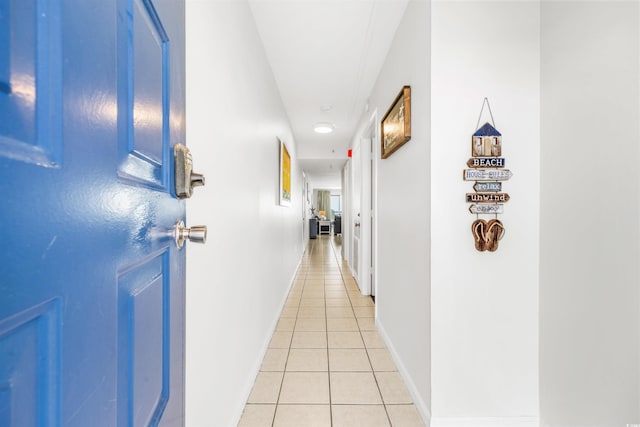 hall with light tile patterned floors