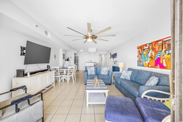 living room featuring light tile patterned floors and ceiling fan