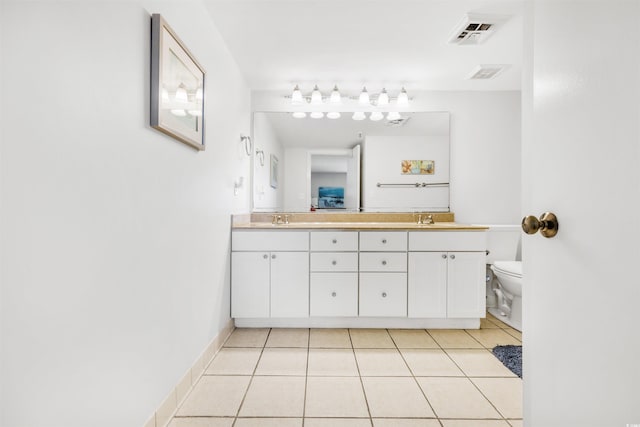 bathroom with tile patterned floors, vanity, and toilet