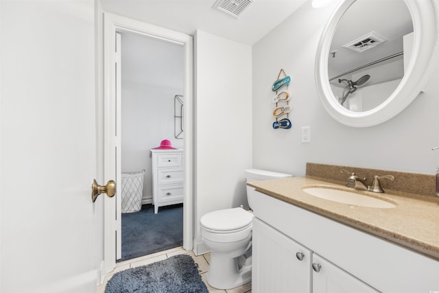 bathroom with tile patterned flooring, vanity, and toilet