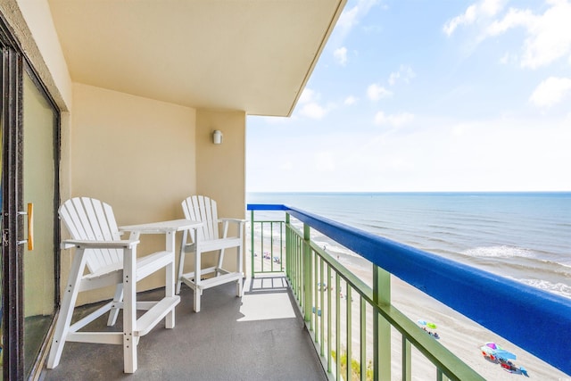 balcony featuring a water view and a view of the beach