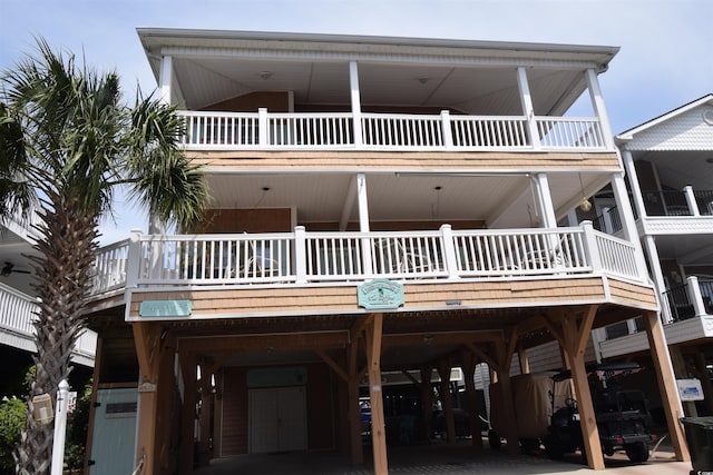 raised beach house with a carport and a balcony