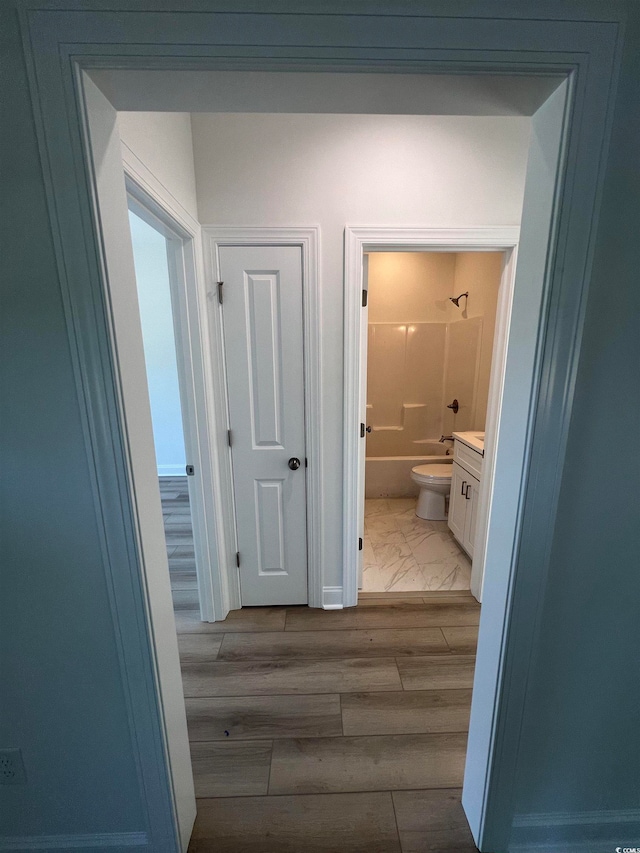 hallway with hardwood / wood-style floors