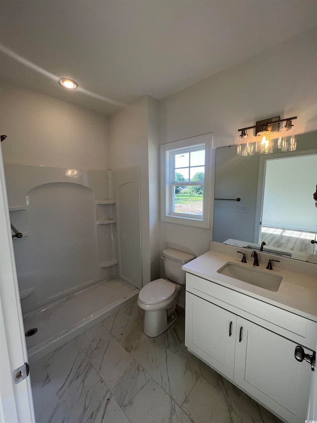 bathroom featuring a shower, vanity, and toilet