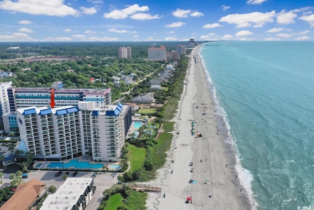 drone / aerial view with a water view, a view of city, and a view of the beach