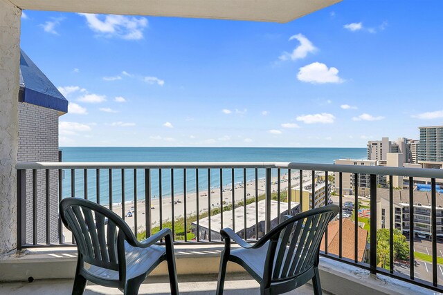 balcony featuring a beach view and a water view