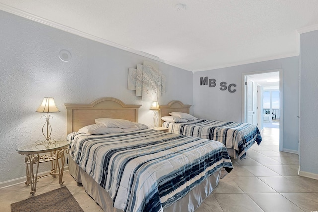 bedroom with light tile patterned floors, baseboards, crown molding, and a textured wall