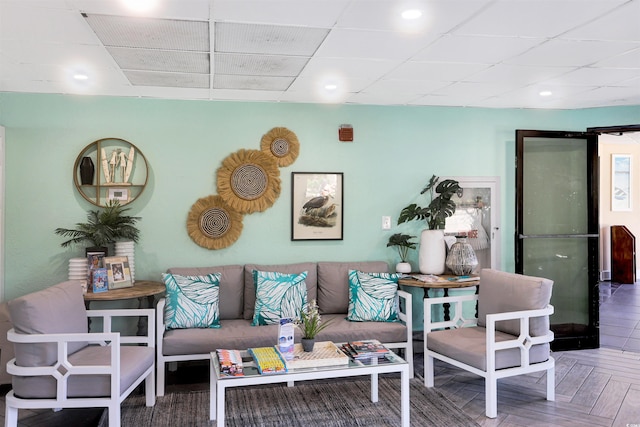 living room featuring a paneled ceiling