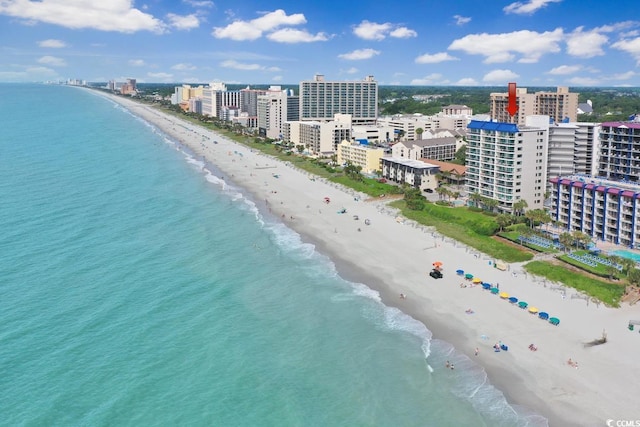 aerial view featuring a water view, a view of the beach, and a city view