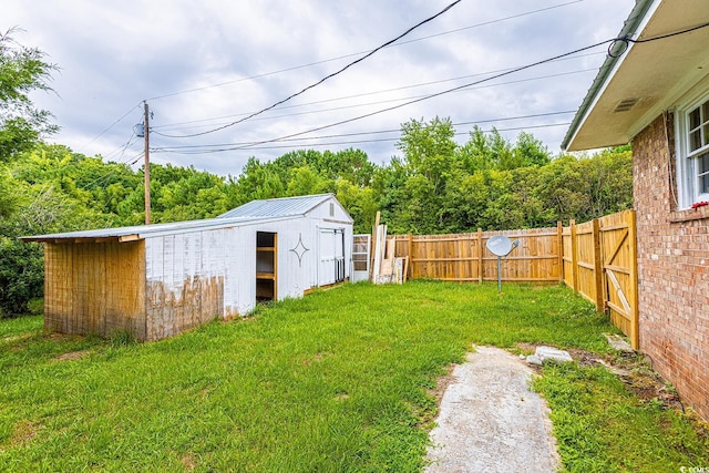 view of yard featuring an outbuilding and a fenced backyard