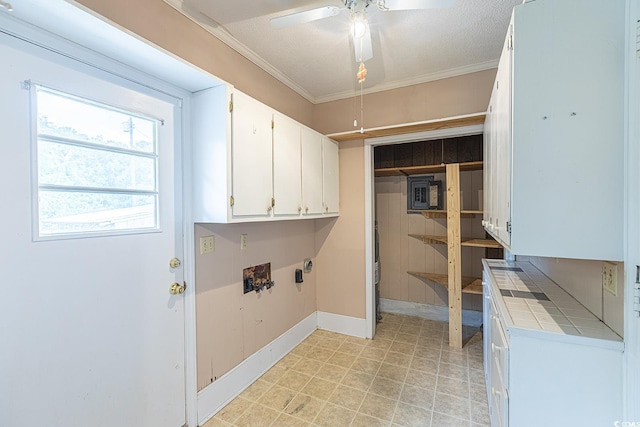 laundry area with washer hookup, a textured ceiling, cabinet space, crown molding, and ceiling fan