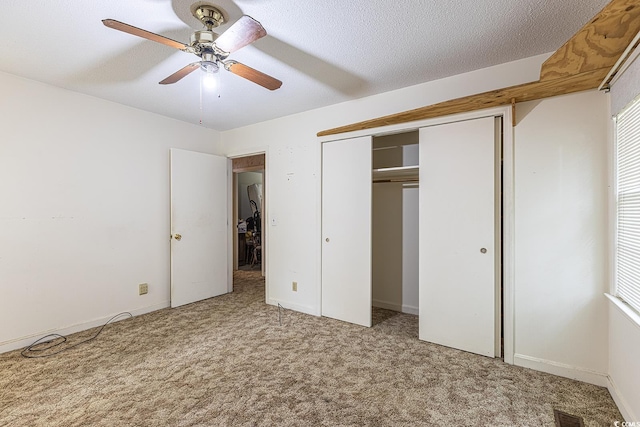 unfurnished bedroom featuring carpet flooring, visible vents, and a textured ceiling