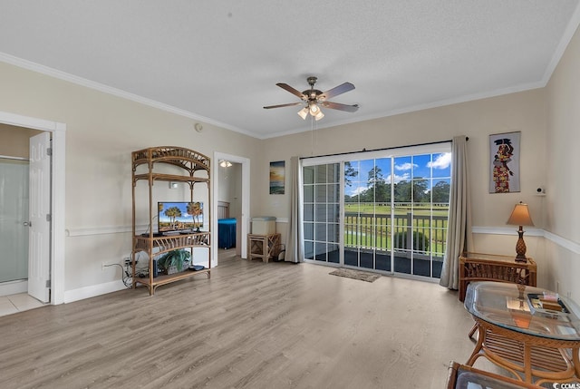 interior space with light wood finished floors, a textured ceiling, and crown molding