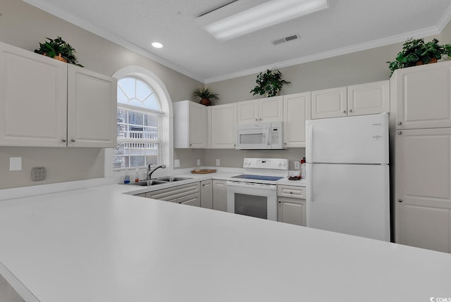 kitchen with light countertops, white appliances, a sink, and white cabinets