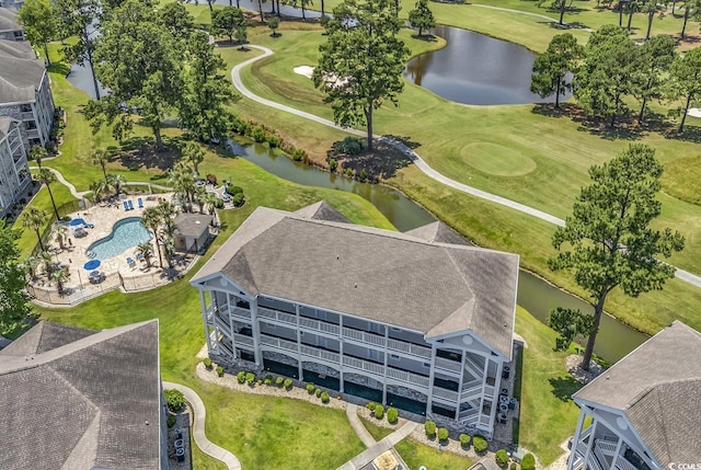 birds eye view of property with a water view and golf course view