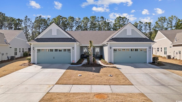 view of front of house with cooling unit and a garage