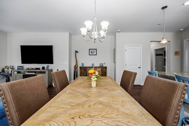 dining room with a chandelier and dark wood-type flooring