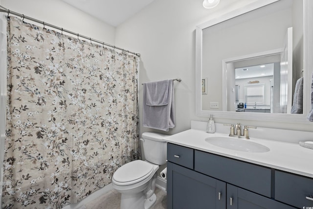 bathroom featuring vanity, toilet, and walk in shower