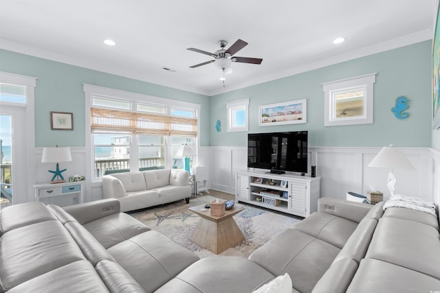 living room featuring crown molding, ceiling fan, and light hardwood / wood-style floors