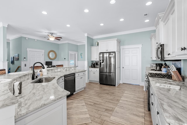 kitchen featuring appliances with stainless steel finishes, white cabinetry, sink, ornamental molding, and light stone countertops