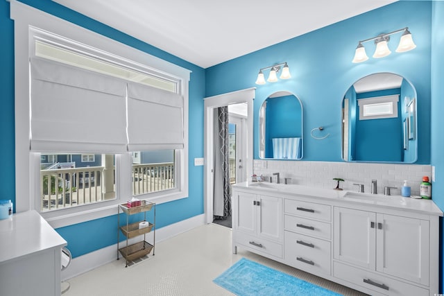 bathroom featuring vanity and decorative backsplash