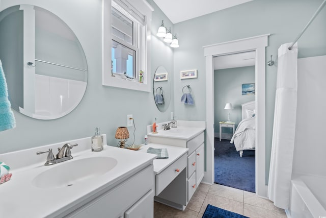 bathroom featuring tile patterned flooring, vanity, and shower / bath combination with curtain