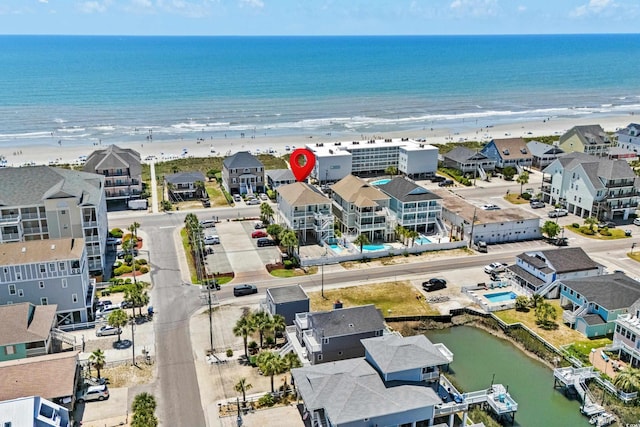 drone / aerial view with a water view and a beach view