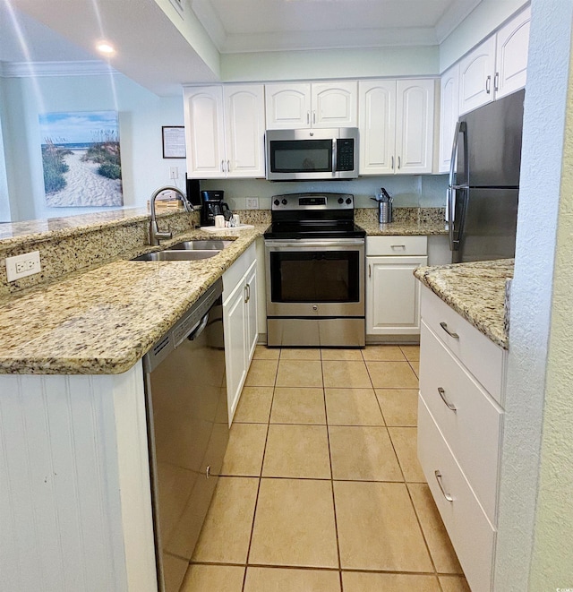 kitchen featuring light stone counters, sink, white cabinetry, appliances with stainless steel finishes, and ornamental molding