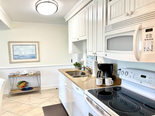 kitchen with sink, crown molding, white appliances, light tile patterned floors, and white cabinets