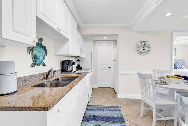 kitchen with crown molding, light tile patterned floors, white cabinetry, a sink, and white appliances