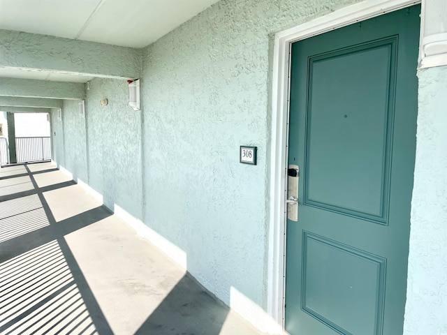 doorway to property featuring stucco siding