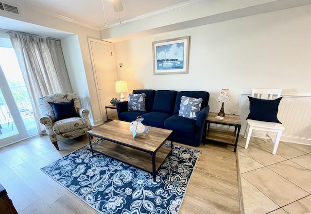 living room featuring hardwood / wood-style floors and crown molding