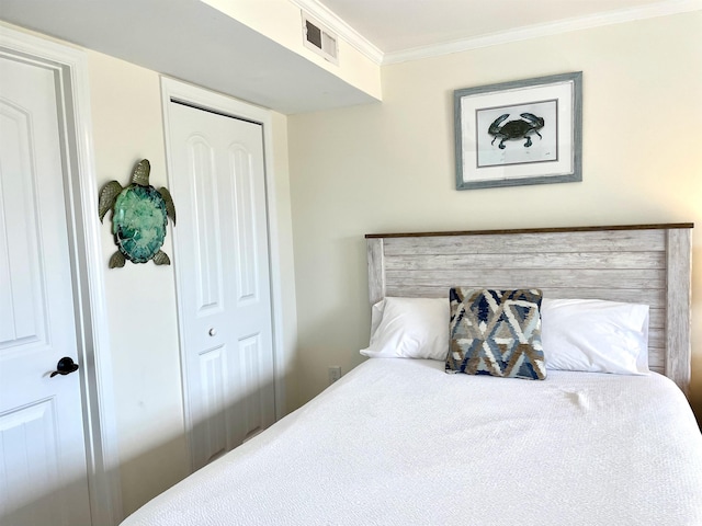 bedroom with crown molding and a closet