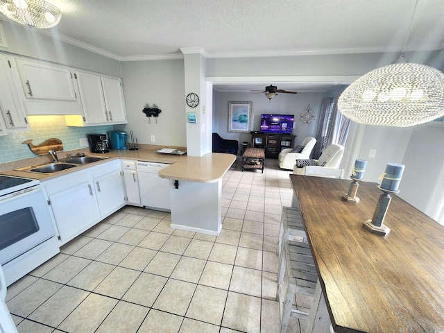 kitchen with white cabinets, white appliances, decorative light fixtures, and sink