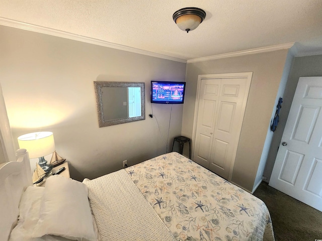 carpeted bedroom with a textured ceiling, a closet, and ornamental molding