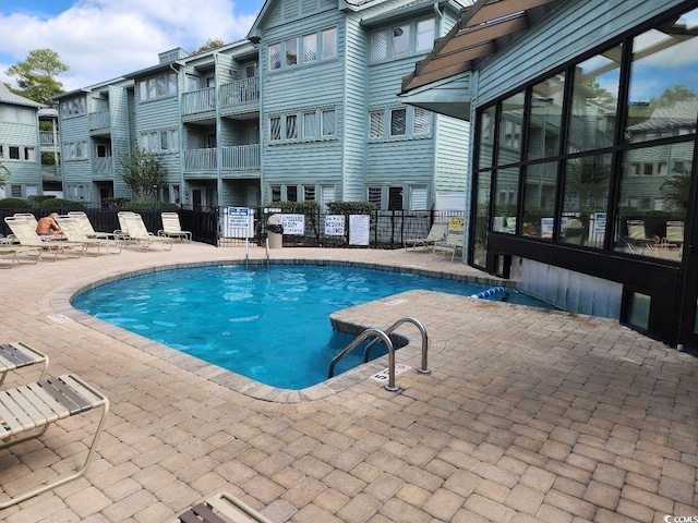 view of swimming pool with a patio