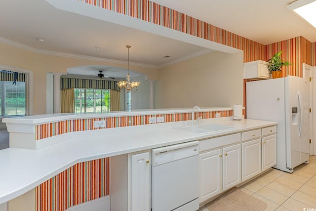 kitchen featuring a wealth of natural light, sink, ceiling fan with notable chandelier, and white appliances