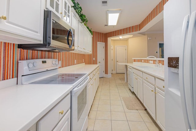 kitchen featuring white appliances, crown molding, sink, white cabinetry, and light tile patterned flooring