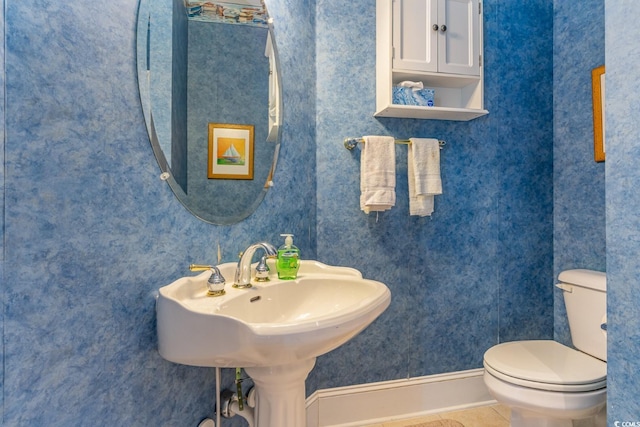 bathroom featuring tile patterned flooring and toilet