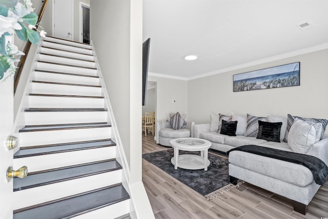 living room with crown molding and hardwood / wood-style flooring