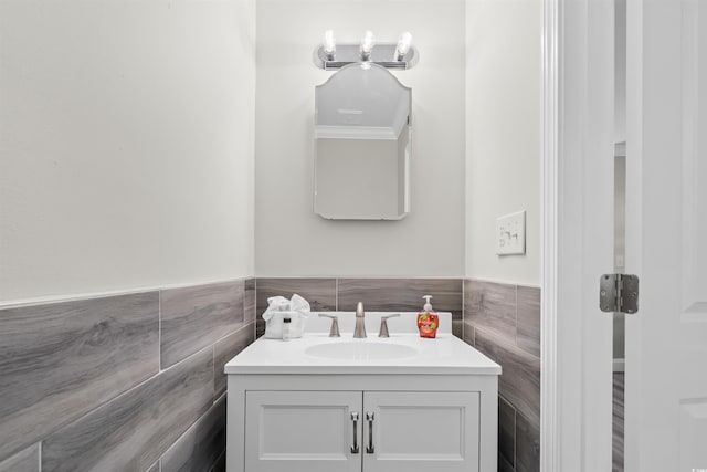 bathroom featuring tile walls, tasteful backsplash, and large vanity