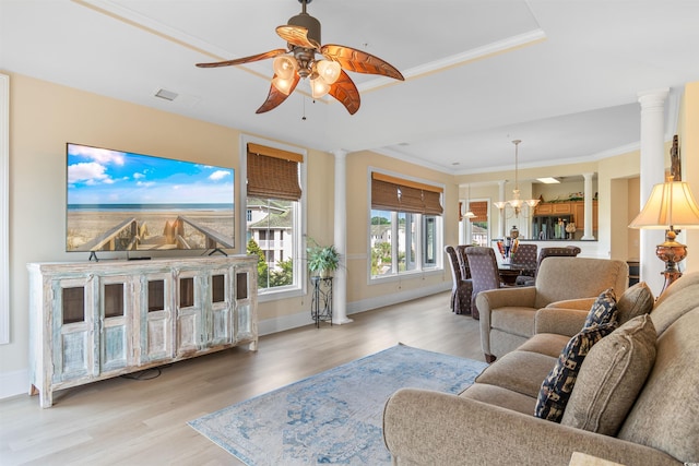 living room with ornate columns, crown molding, light hardwood / wood-style floors, and ceiling fan with notable chandelier